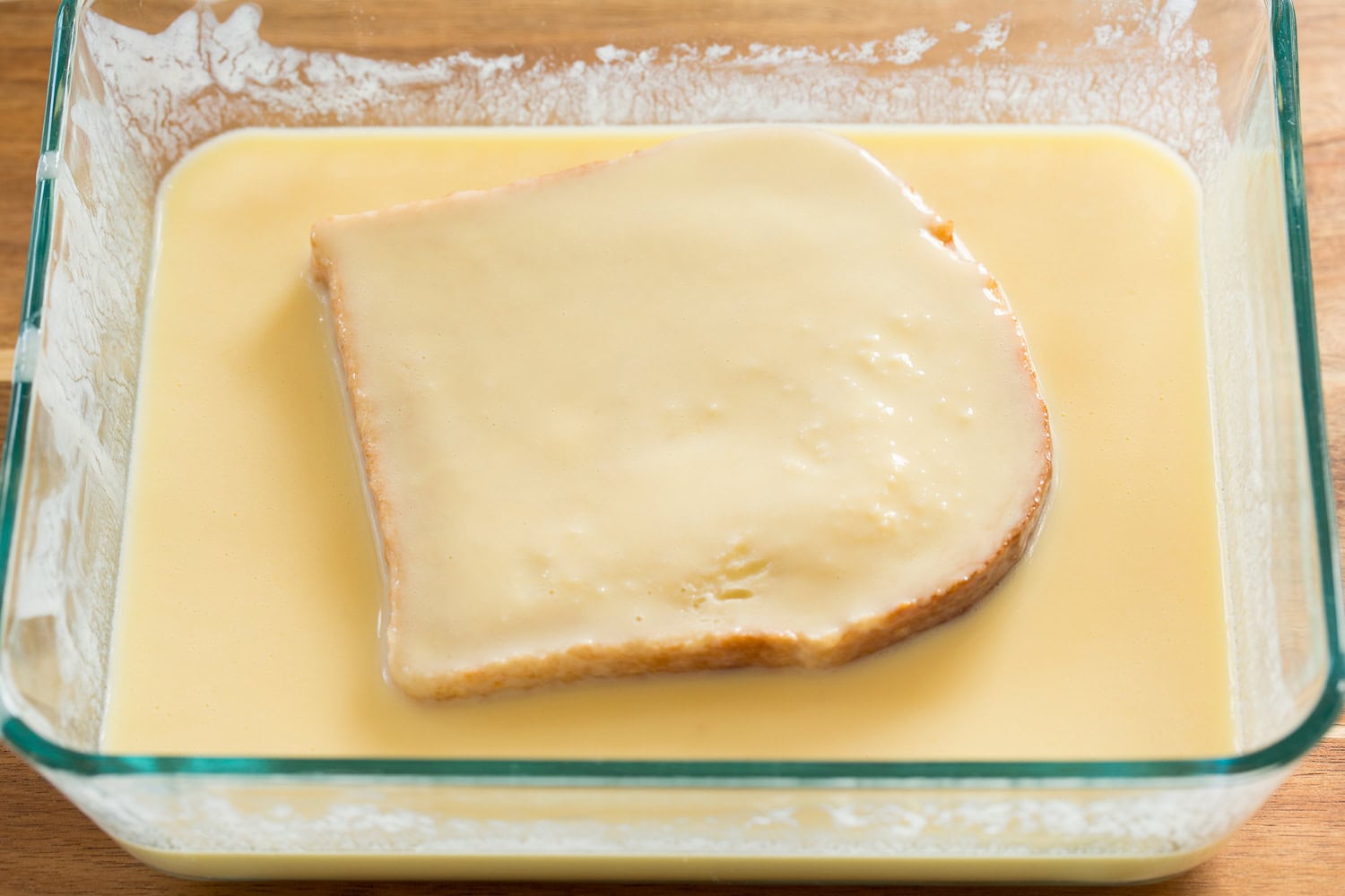 Buttermilk French Toast French bread being soaked in buttermilk egg mixture.