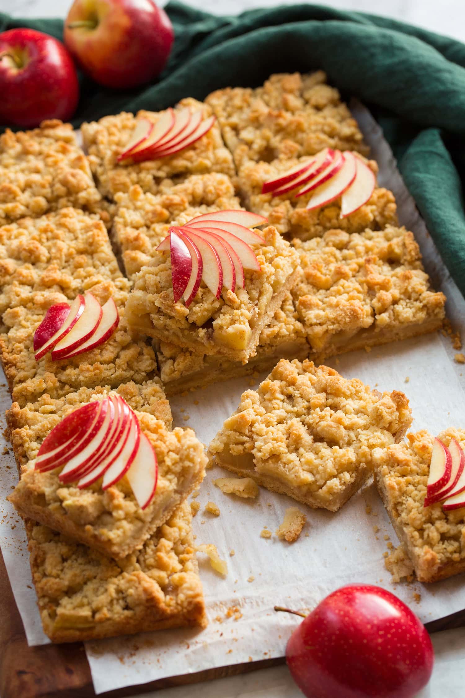 Apple Pie Bars Apple pie bars cut into squares with thin apple slices on top for garnish.