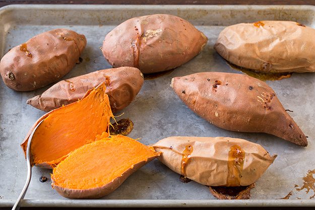 Showing how to make sweet potato casserole. Staring by baking sweet potatoes.