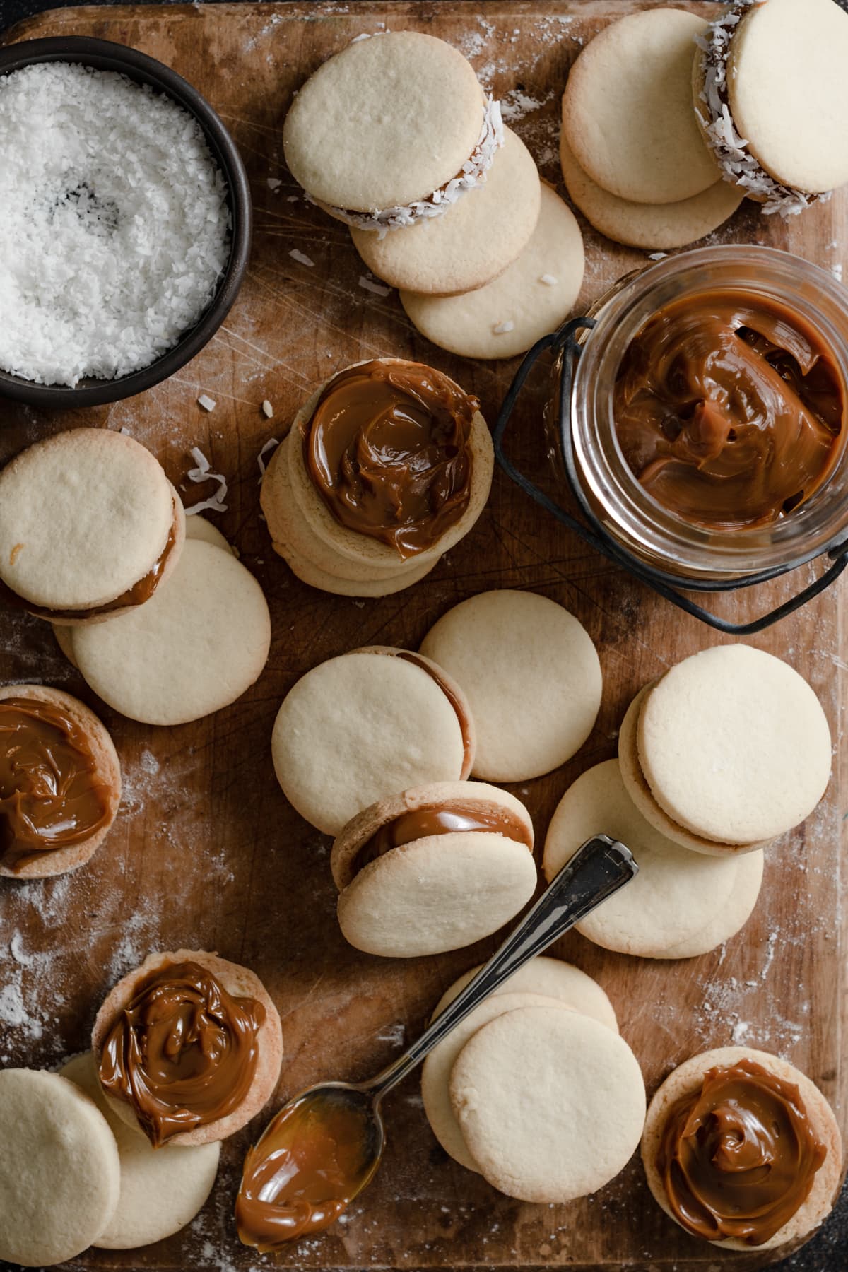 Filling alfajores cookies with dulce de leche.