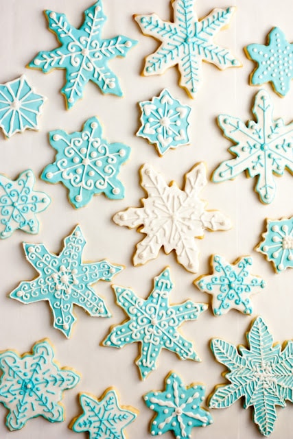Iced Sugar Cookies cut into snowflake shapes.