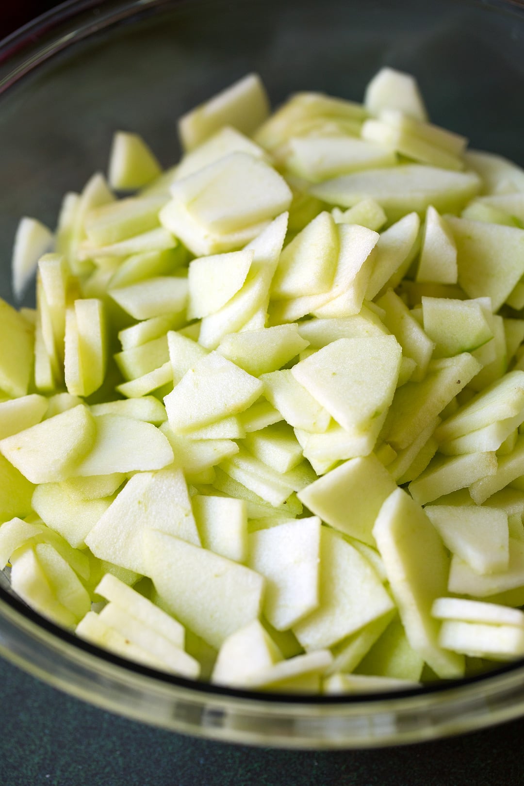 Sliced apples in a glass bowl.
