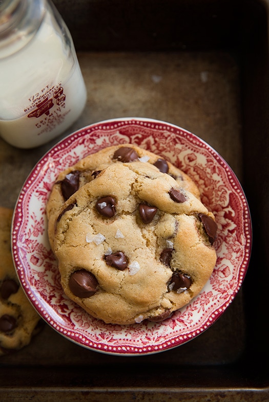 Gluten-Free Chocolate Chip Cookies on red and white plate next to jar of milk