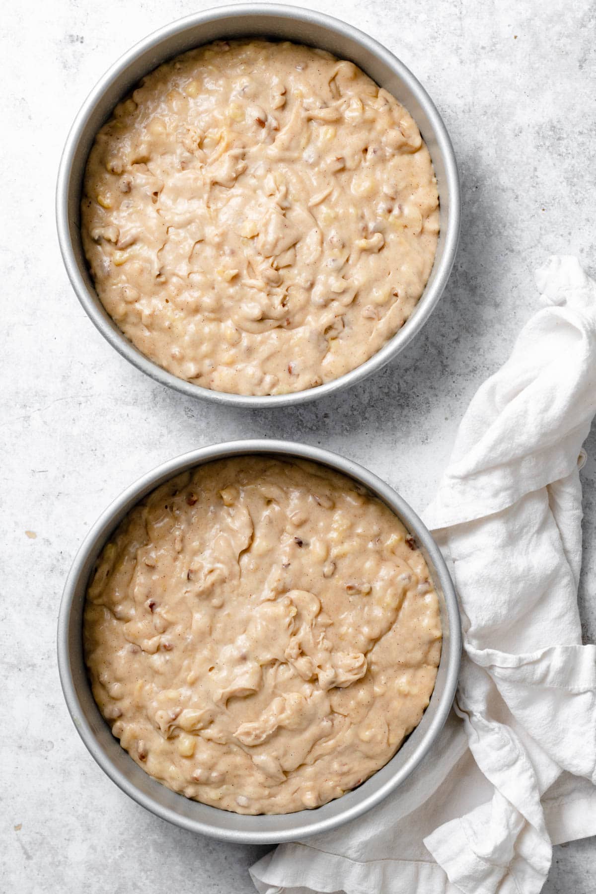 Showing how to make hummingbird cake. Batter poured into two cake pans. 