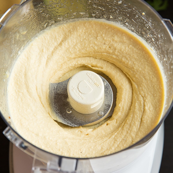This creamy delicious homemade hummus recipe is the best! It can be made in under 10 minutes and it makes the perfect midday snack for you and your family, or take it to a party and impress your friends! #cookingclassy #hummus #avocado #dips Avocado Hummus getting made in a blender
