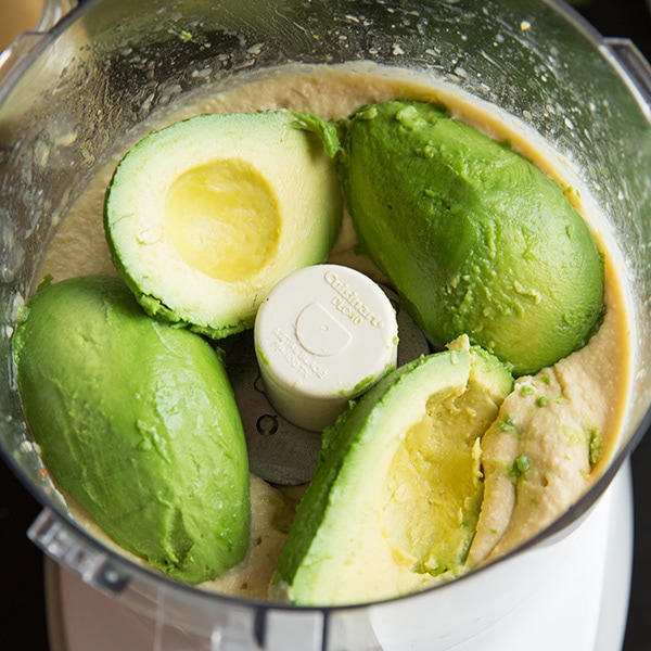 This creamy delicious homemade hummus recipe is the best! It can be made in under 10 minutes and it makes the perfect midday snack for you and your family, or take it to a party and impress your friends! #cookingclassy #hummus #avocado #dips A process shot of making avocado hummus