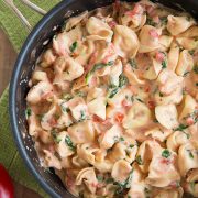 Creamy spinach tomato tortellini in a skillet