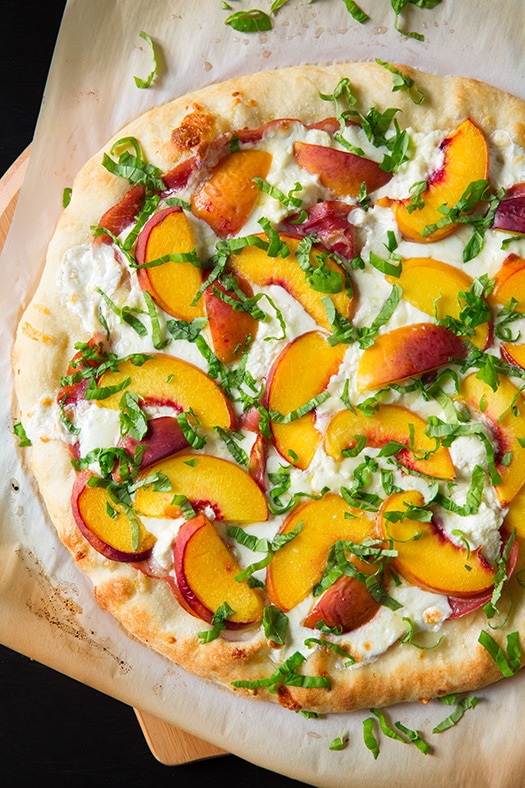 Peach and Prosciutto Pizza garnished with fresh basil