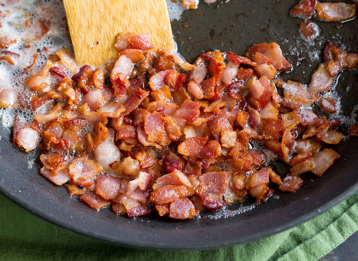 Creamy Ham Potato Corn Chowder sauteing bacon in skillet