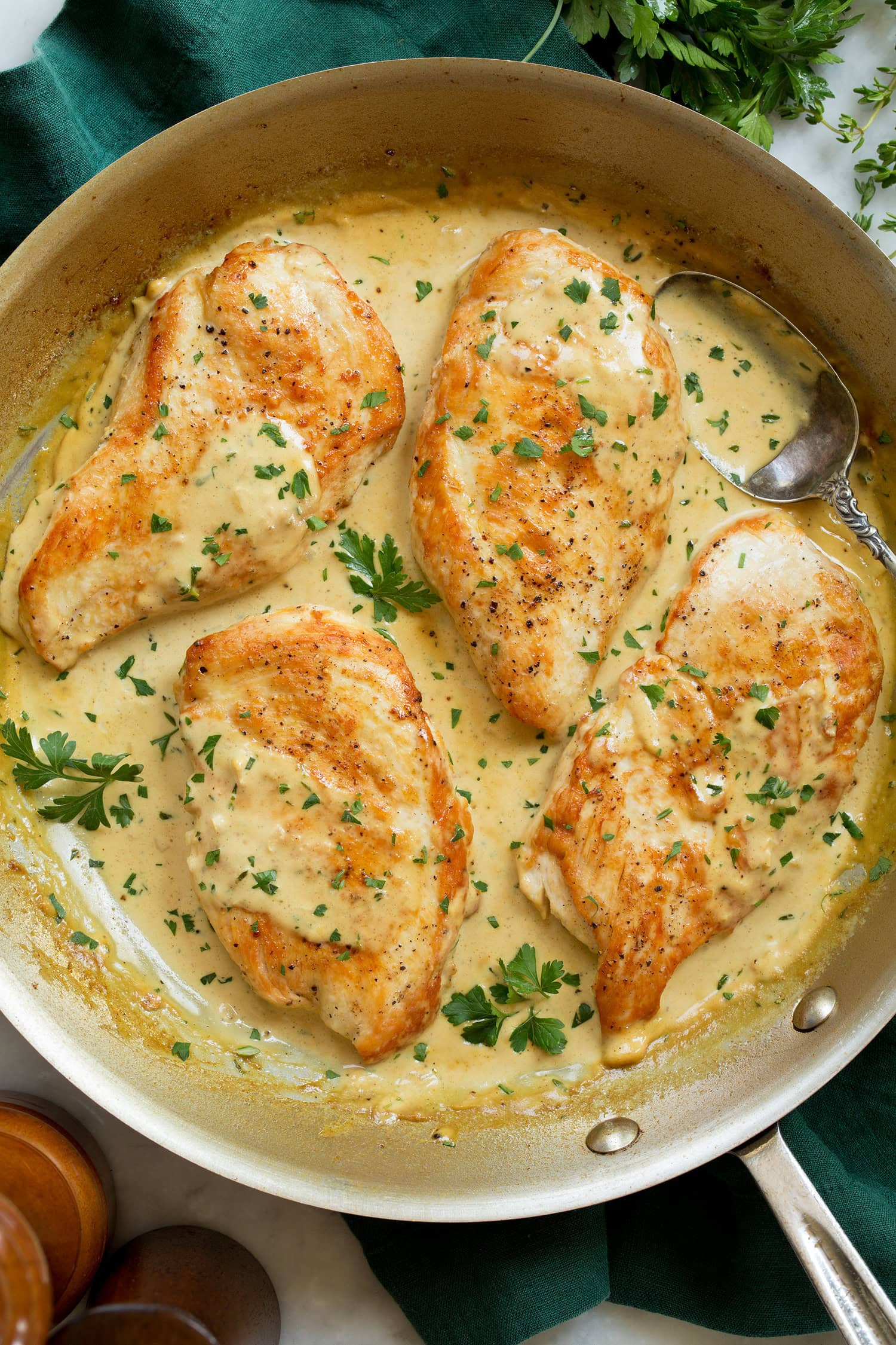 Creamy dijon mustard chicken in a stainless still skillet.