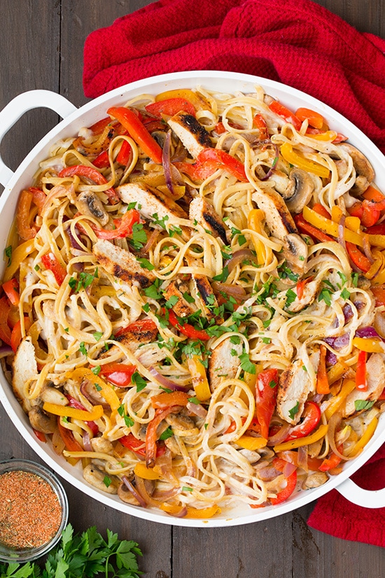 Cajun Chicken Pasta in serving dish wit colorful veggies