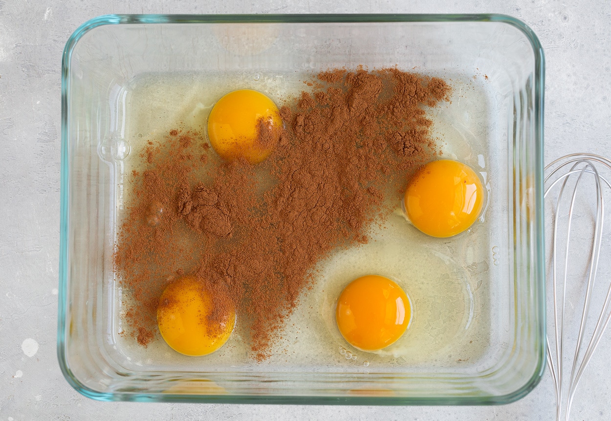 Showing how to make french toast. Whisking eggs and cinnamon in shallow dish.