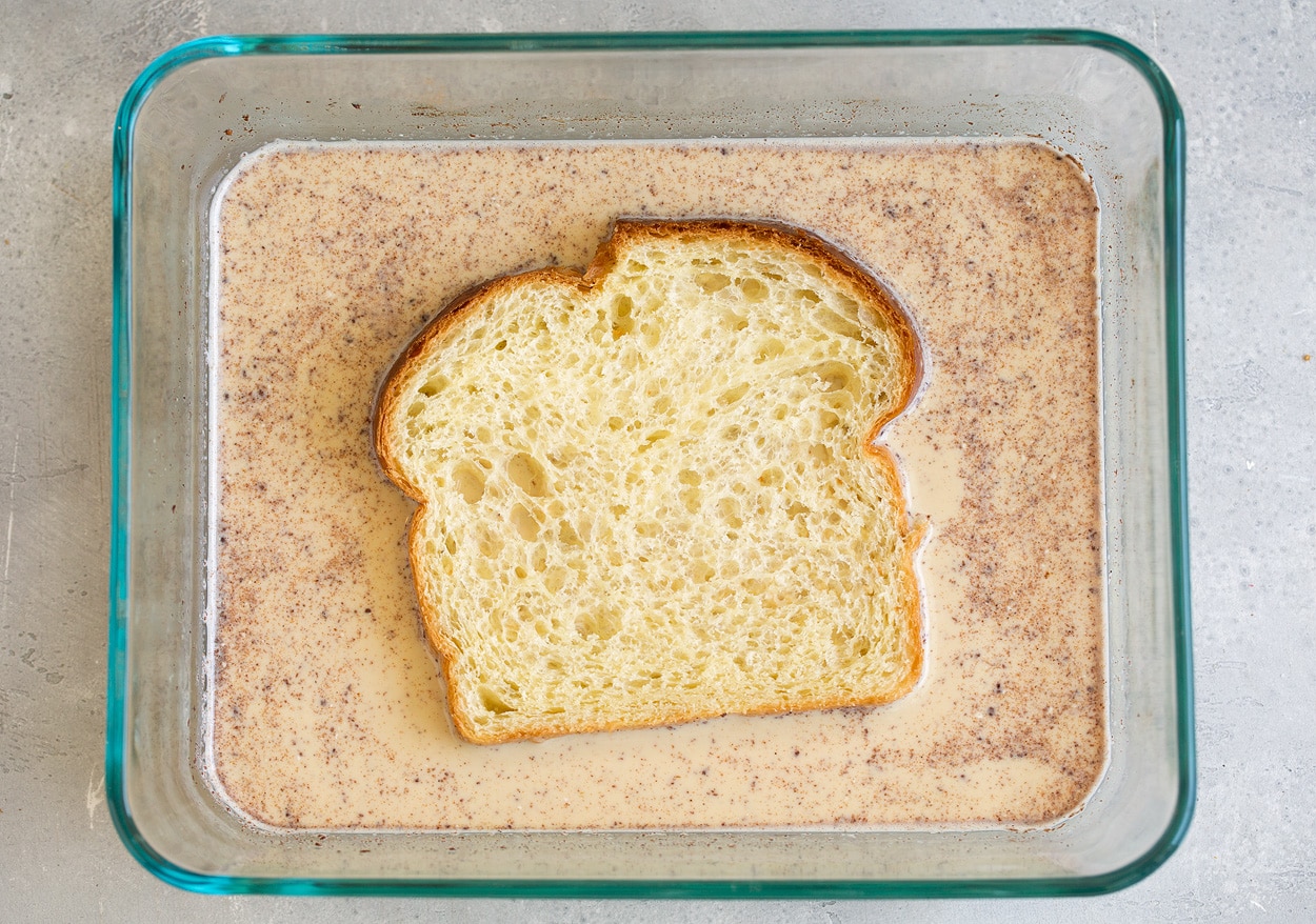 Bread dipped in custard mixture for french toast