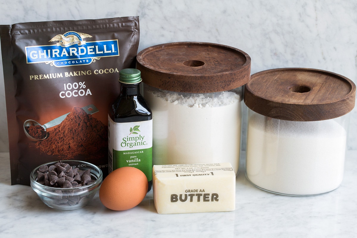 Ingredients for small batch brownies displayed. Includes flour, sugar, butter, vanilla, egg, cocoa powder and optional chocolate chips.