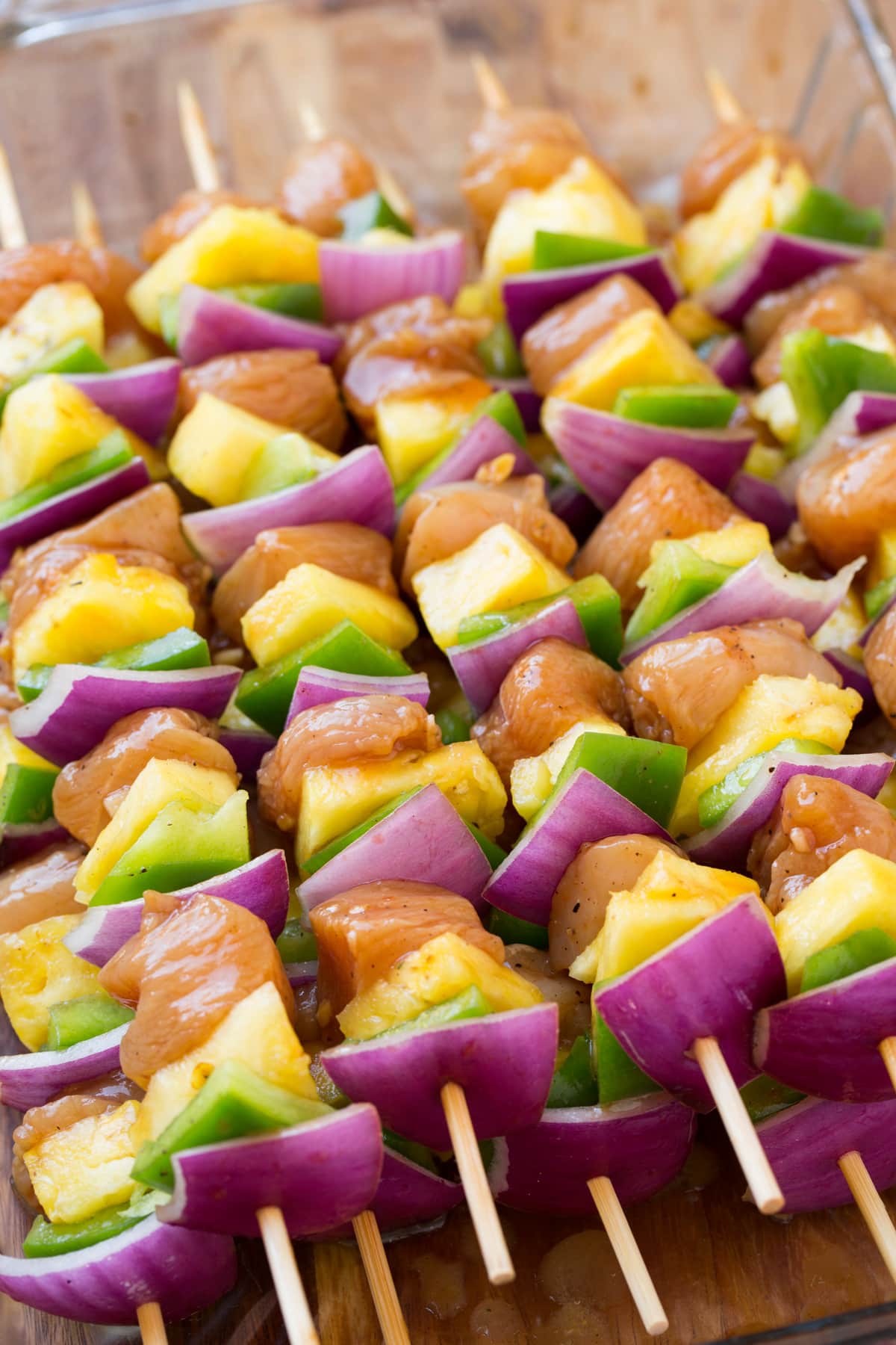 Chicken kebabs with bell pepper red onion and pineapple. Shown before cooking.