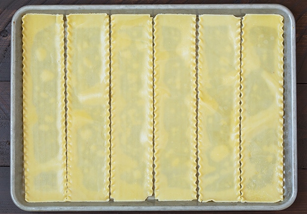 Lasagna pasta on a baking tray ready for making lasagna roll ups