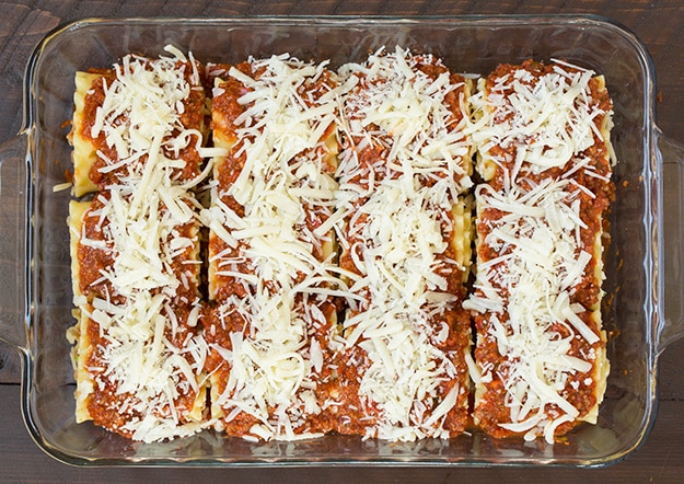 Mozzarella cheese sprinkled on top of Lasagna Roll Ups