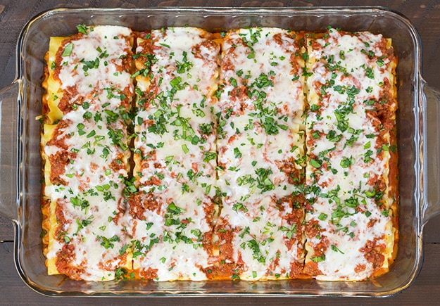 Lasagna Roll Ups out of the oven with melted cheese and basil