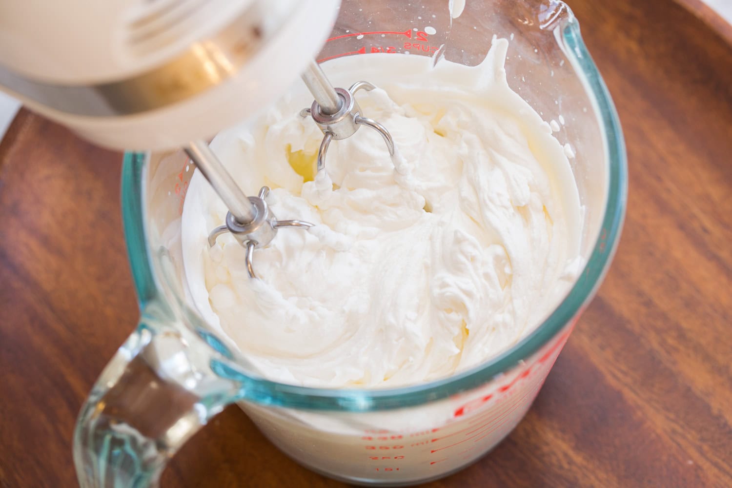 Whipped cream whipped to stiff peaks in glass jar.