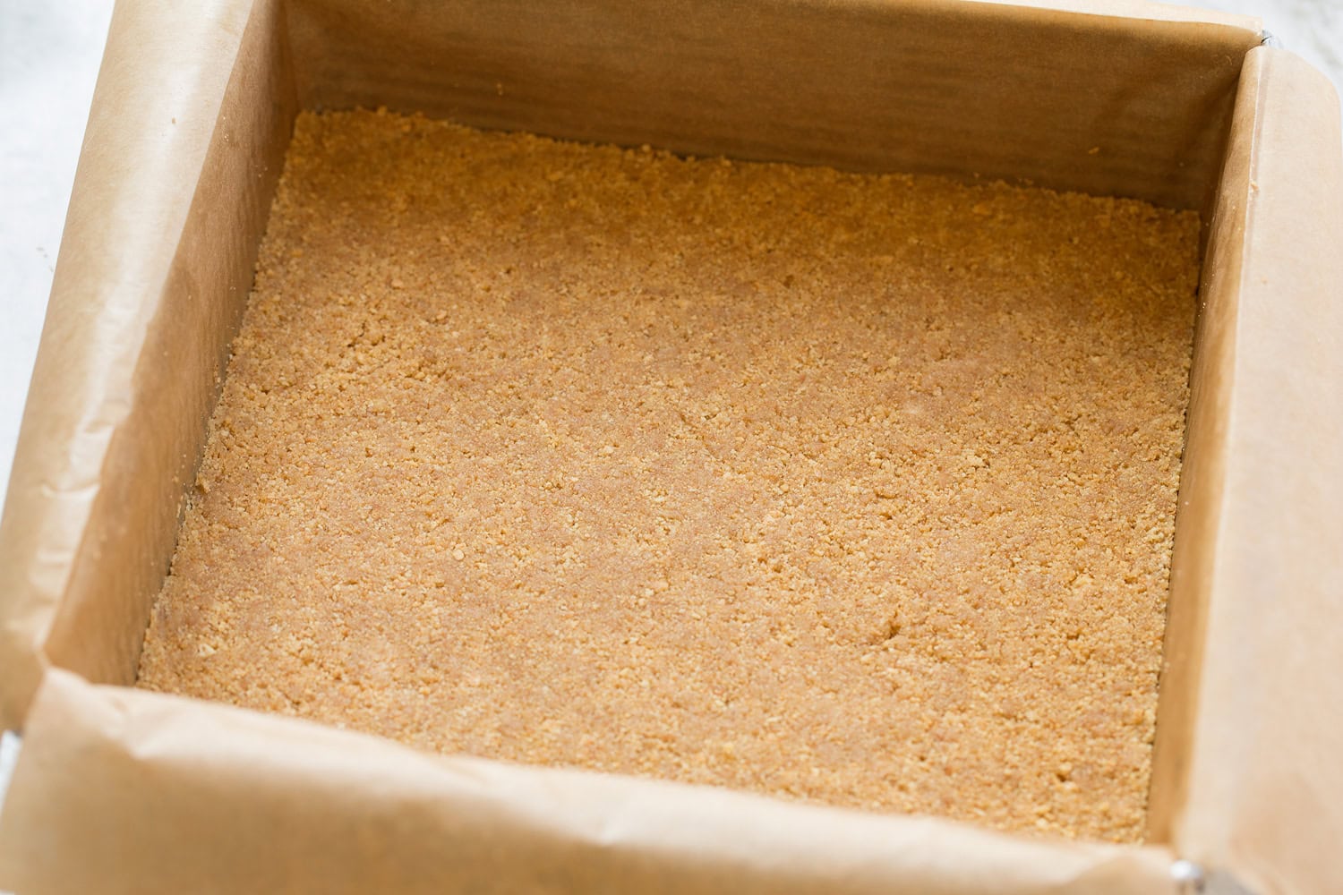 Graham cracker crust pressed into baking dish.
