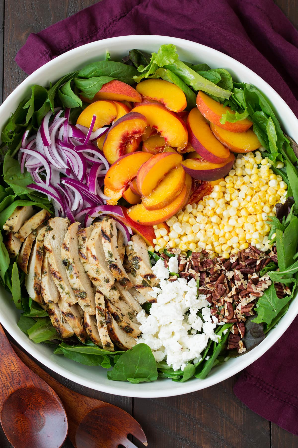 Peach salad ingredients in bowl before tossing.