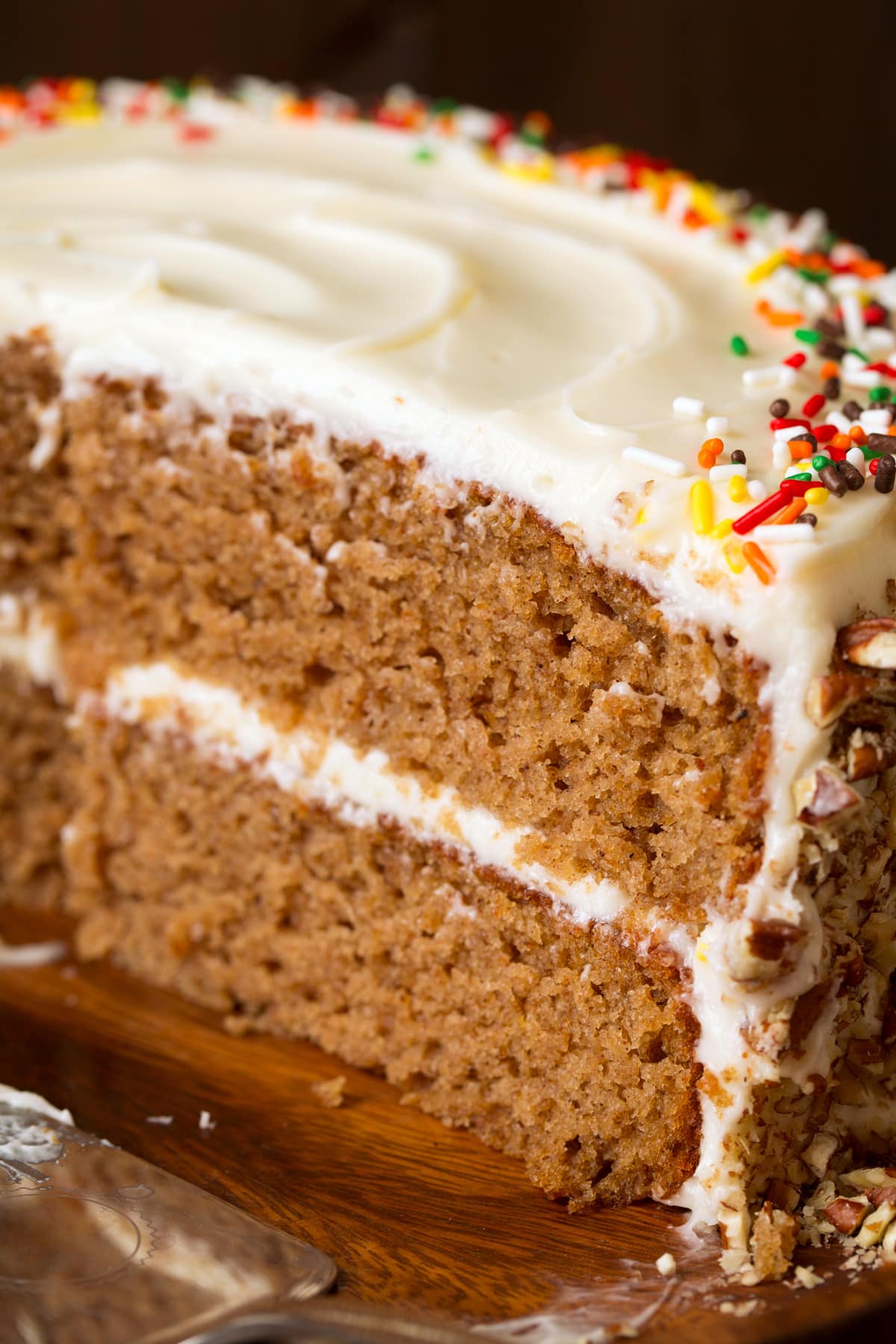 Close up image of spice cake showing texture and frosting layers.