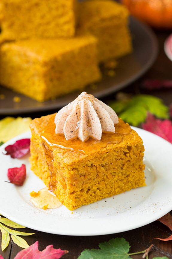 Slice of pumpkin cornbread topped with piped cinnamon honey butter.