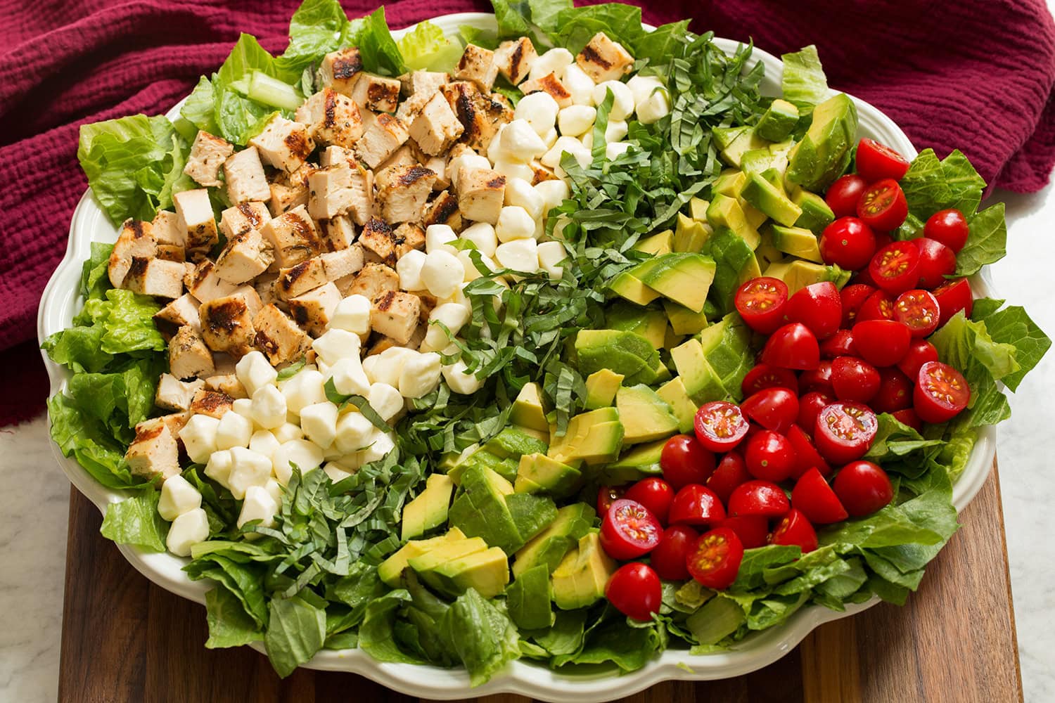 Caprese chopped salad shown layered together before adding dressing.