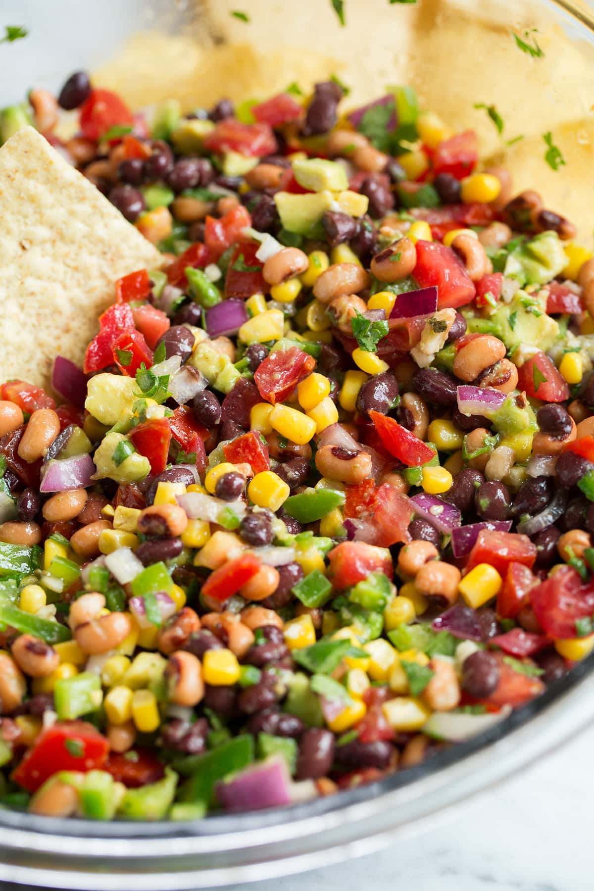 Cowboy Caviar in glass bowl with tortilla chips