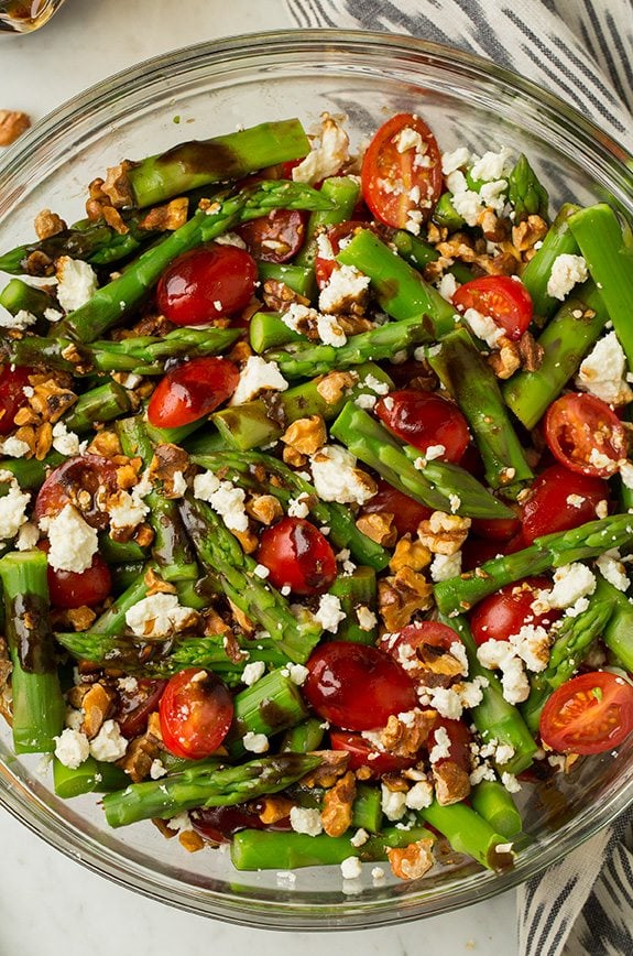 Asparagus, Tomato and Feta Salad with Balsamic Vinaigrette in a large glass bowl