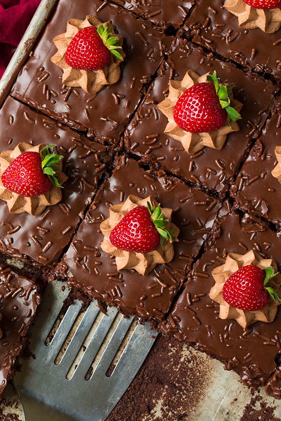 Best chocolate cake in sheet pan topped with mousse and strawberries