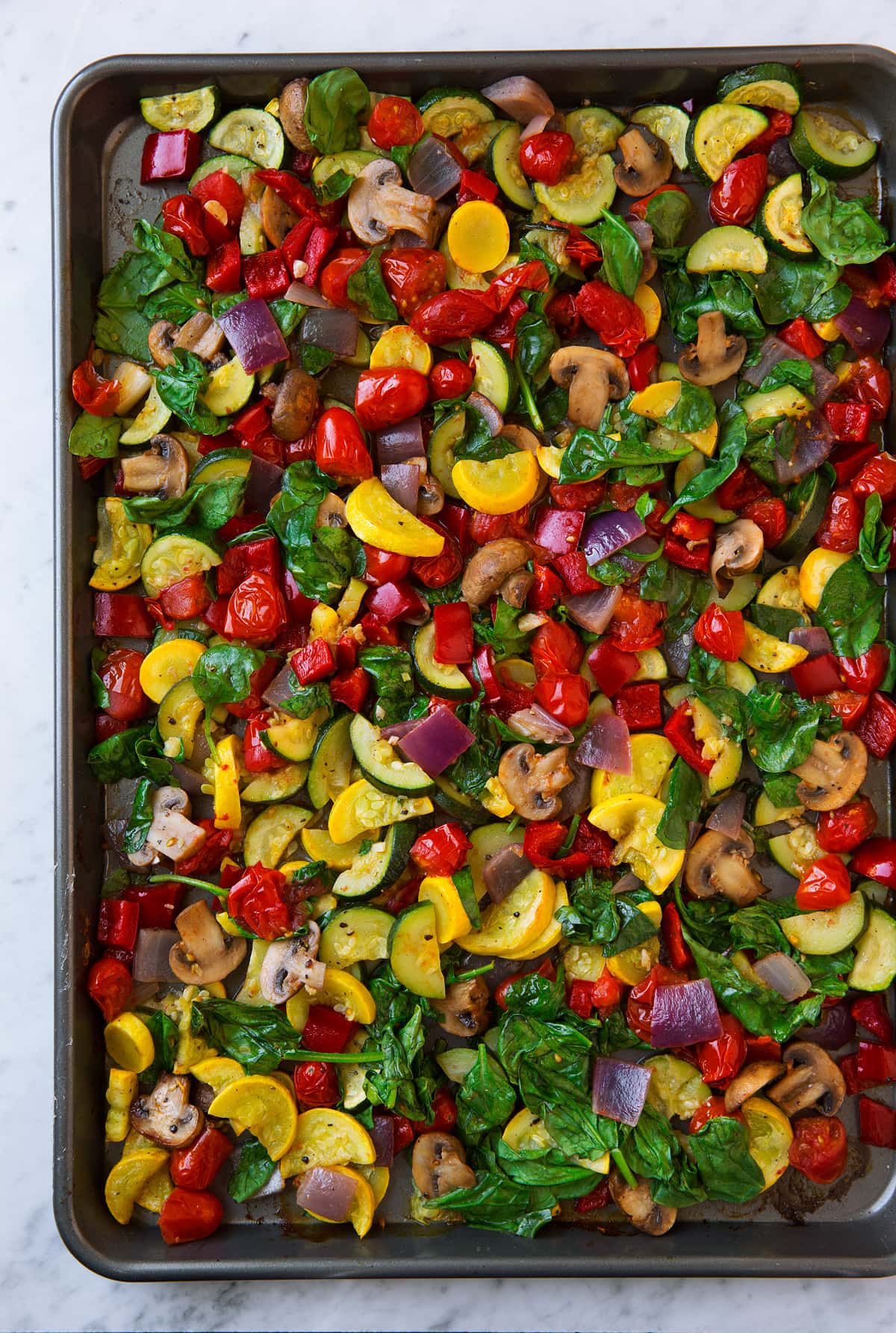 Roasted vegetables on a baking sheet.