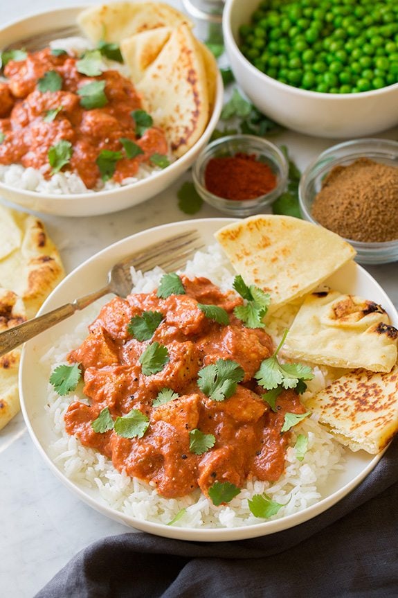 Quick Chicken Tikka Masala two servings shown here in white bowls served over rice with naan 