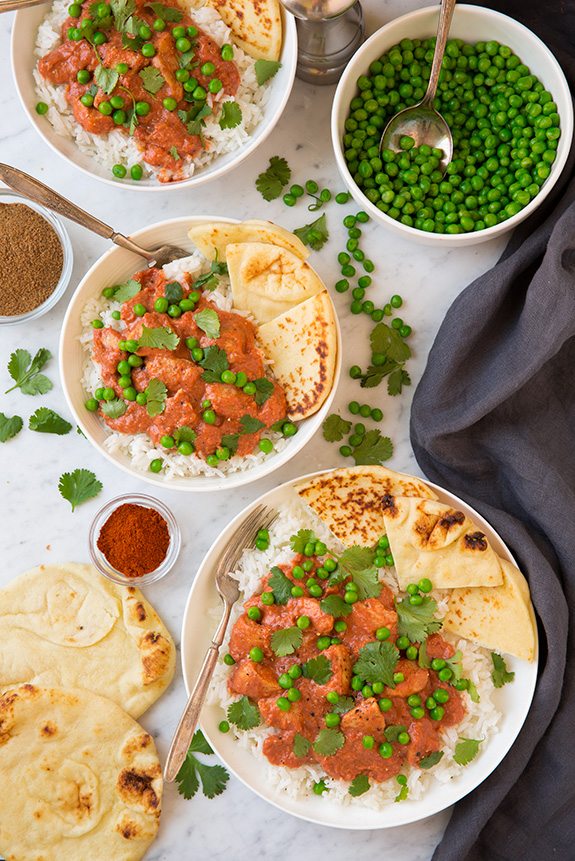 Easy Chicken Tikka Masala served with peas and naan over rice