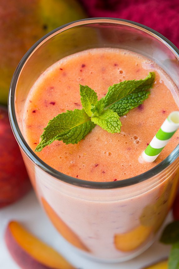 Frozen mango peach Smoothie in Glass With Straw