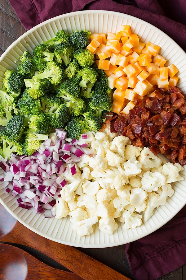 Ingredients for a Broccoli and Cauliflower Salad in a white bowl
