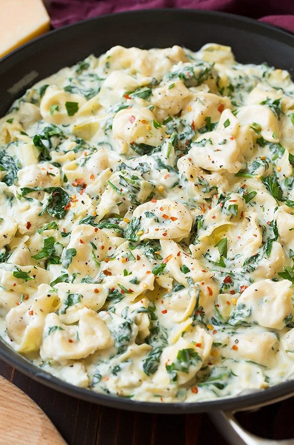 Creamy Spinach Artichoke Tortellini in a skillet.
