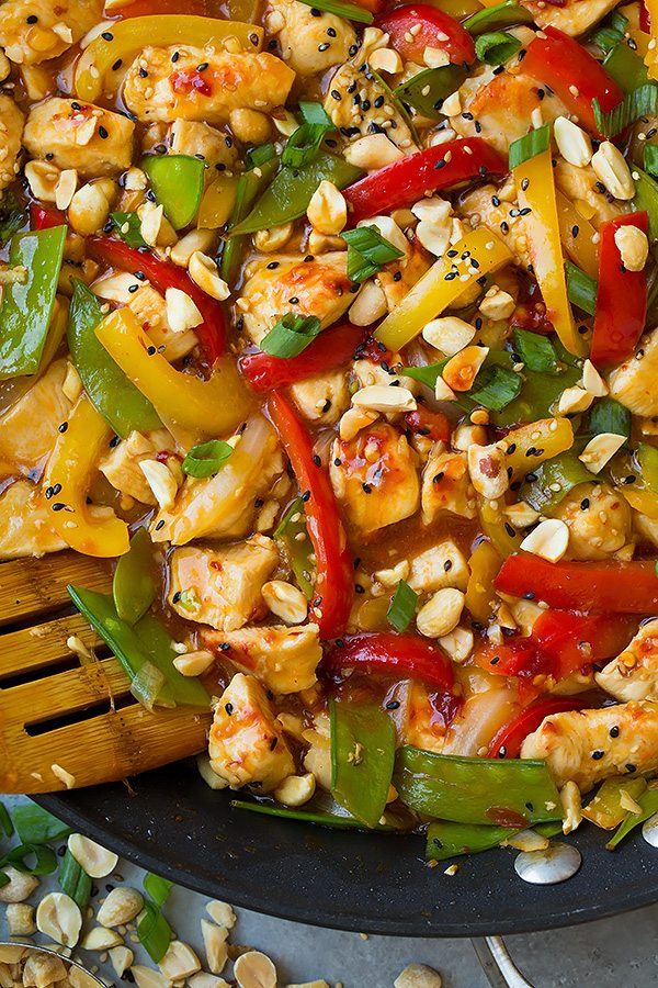 close up of Szechuan Chicken Stir-Fry topped with peanut and scallions