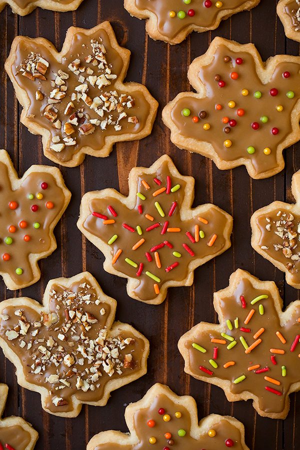 Leaf shape shortbread on a dark wooden surface.