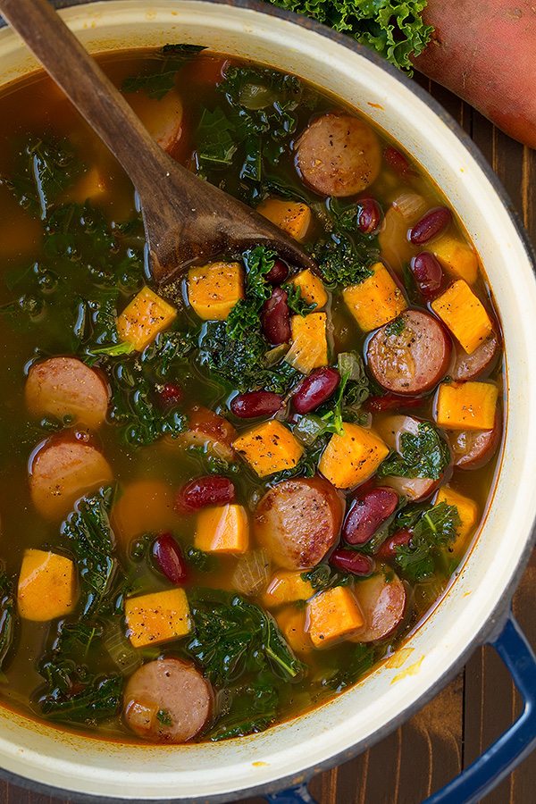 Turkey Sausage, Kale and Sweet Potato Soup in a large blue pot.