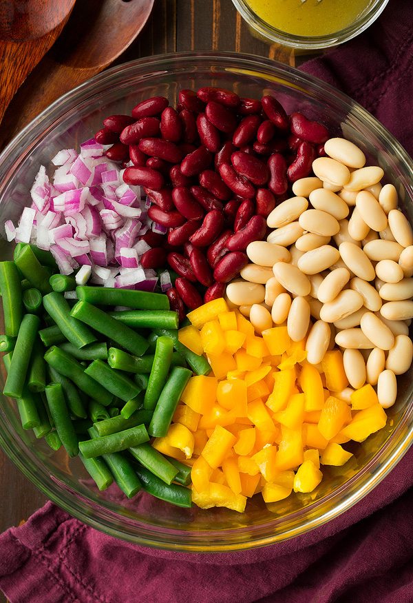 Ingredients for three bean salad in a mixing bowl before tossing.