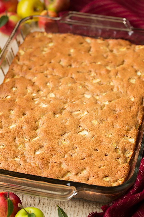 A whole apple cake in a glass baking dish.