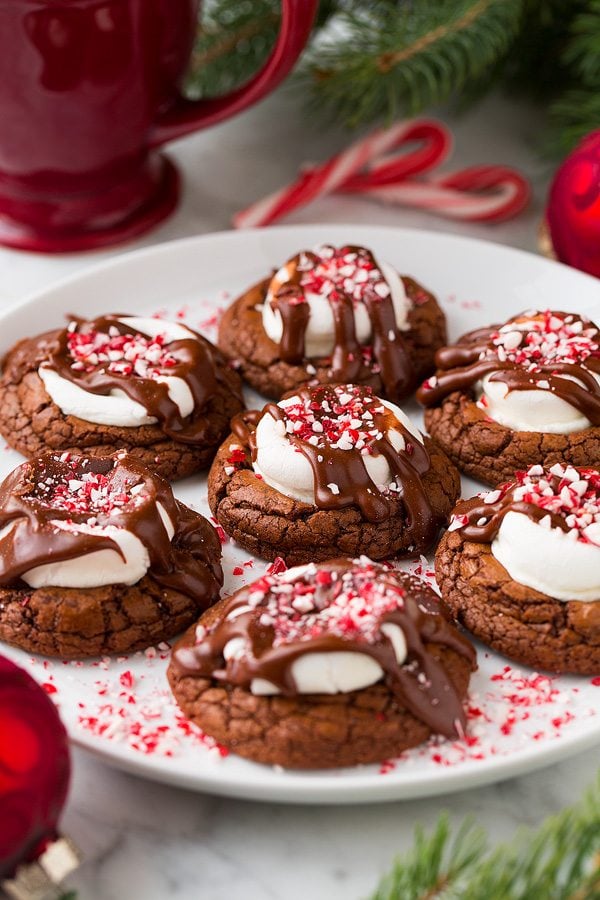 Peppermint Hot Chocolate Cookies on a white serving plate with a red mug in the background.