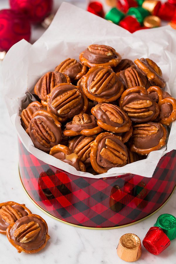 Pretzel Turtles in a Christmas tin with tissue paper. Made with pretzels, rolo candy and pecans.