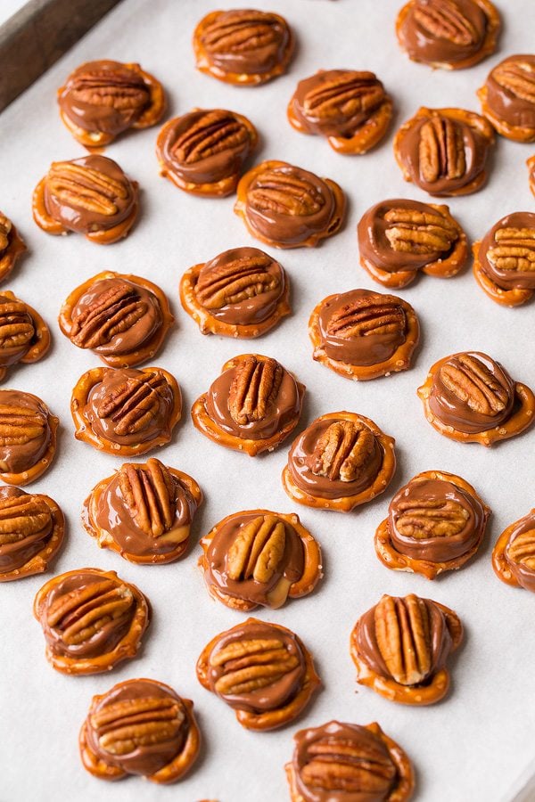 Pretzel Turtles on a baking sheet with parchment paper. 
