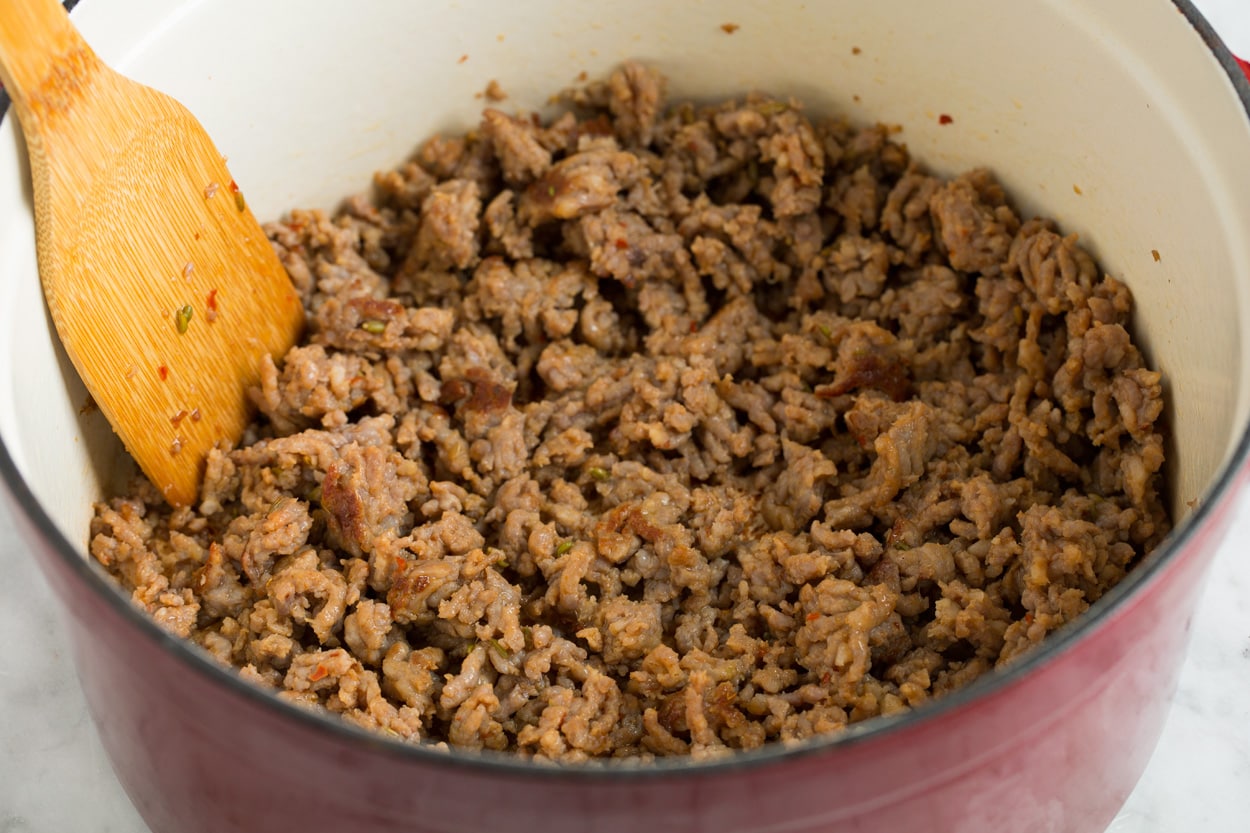 Showing how to brown Italian sausage in a large pot for zuppa toscana soup.