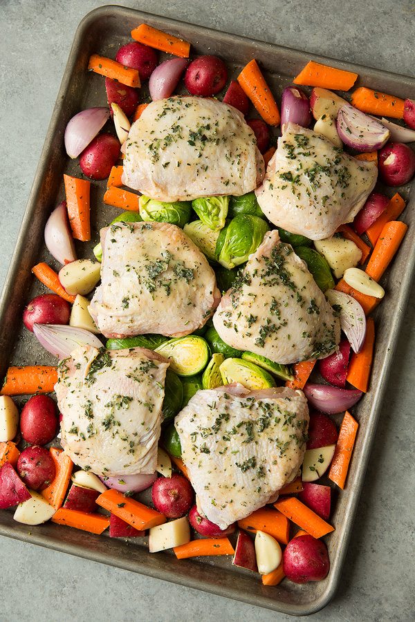 Chicken and veggies on baking sheet before baking.