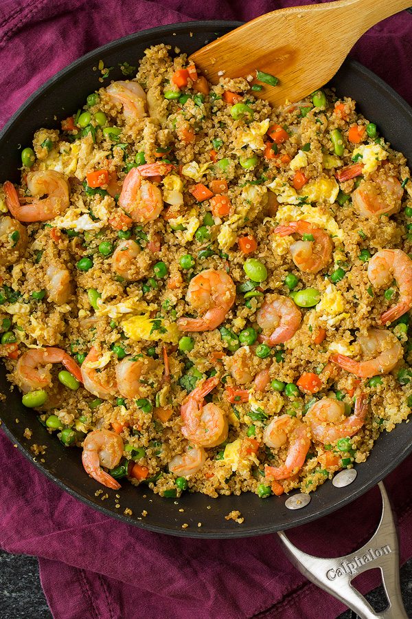 Shrimp Quinoa Fried Rice in a large skillet, Ingredients include shrimp, quinoa, veggies, eggs and seasonings.