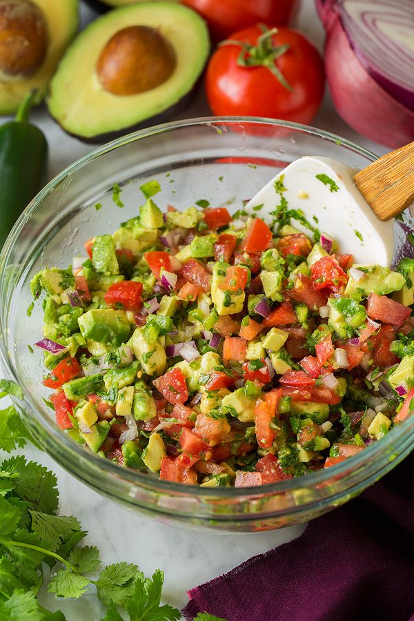 Avocado salsa in a mixing bowl for burrito bowls.