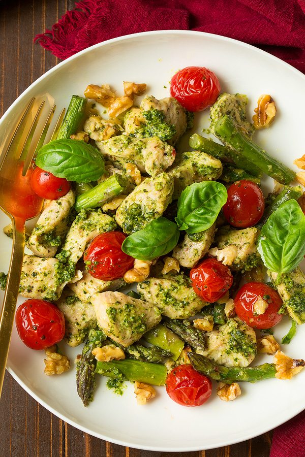 Sheet Pan Pesto Chicken with Asparagus Tomatoes and Walnuts | Cooking Classy pesto chicken and asparagus bake with tomatoes on white plate